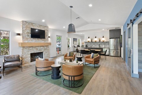 a living room with a fireplace and a table and chairs